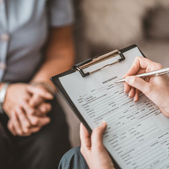 filling out paperwork on a clipboard