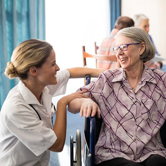 a smiling senior in a wheelchair