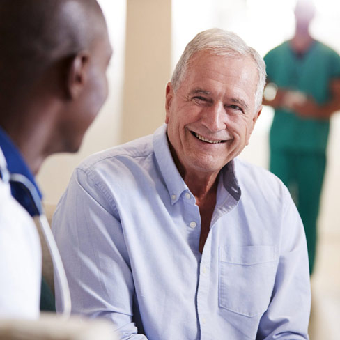 elderly man talking to a doctor